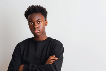 Photo of a stubborn black teenage boy on white background. Concept of adolescence, transition period, puberty, hormonal changes, psychological problems of children, teenagers, young generation. - obrazy, fototapety, plakaty