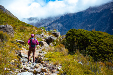hiker girl enjoys a scenic path in southern alps - otira valley track in canterbury, new zealand...
