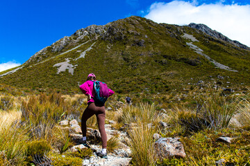 hiker girl enjoys a scenic path in southern alps - otira valley track in canterbury, new zealand...