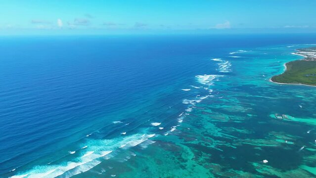 Aerial drone panorama at great barrier reef in the Caribbean Sea, over a yacht, in Punta Cana, Dominican Republic. Tropical seashore with resorts and turquoise caribbean sea. 