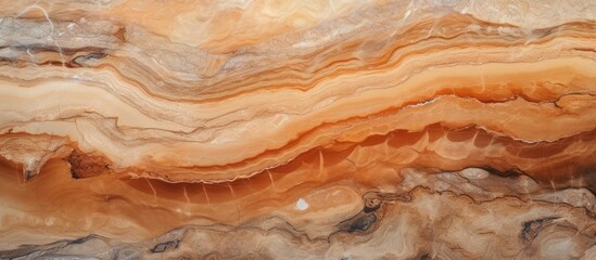 A close up of a bedrocktextured marble with a beautiful amber swirl pattern resembling wood grain....