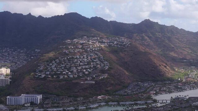 Iconic Hawaii Kai residential area. Honolulu suburban town nested on hills of scenic Hawaiian mountains. Houses build on steep hill overlooking ocean. Real estate background on Oahu island, buy offer