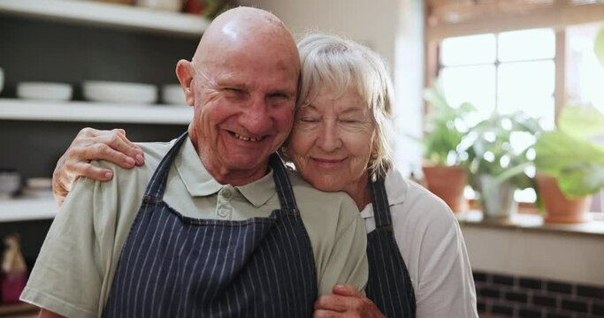 Happy, face and old couple in kitchen hug with love, support and care in marriage or retirement. Elderly, man and woman embrace with kindness and gratitude for cooking dinner in home together