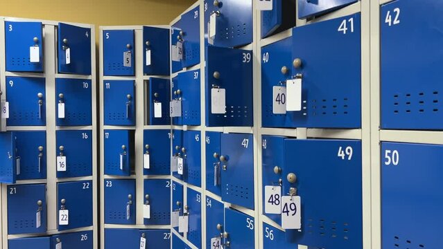Rows of metal storage lockers in a supermarket, school, college, university, gym, pool, airport or other public place