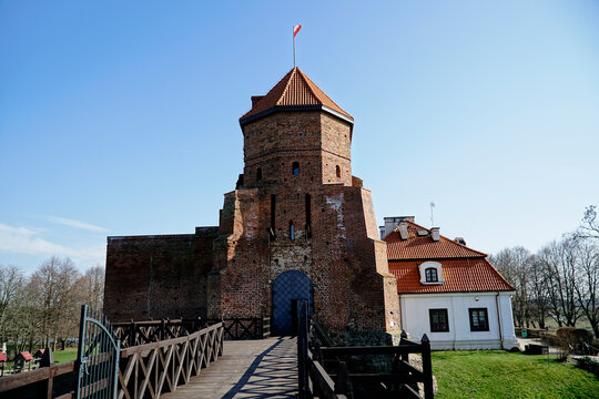 Liw, Poland - March 10th, 2024 - Gothic medieval castle and wooden footbridge