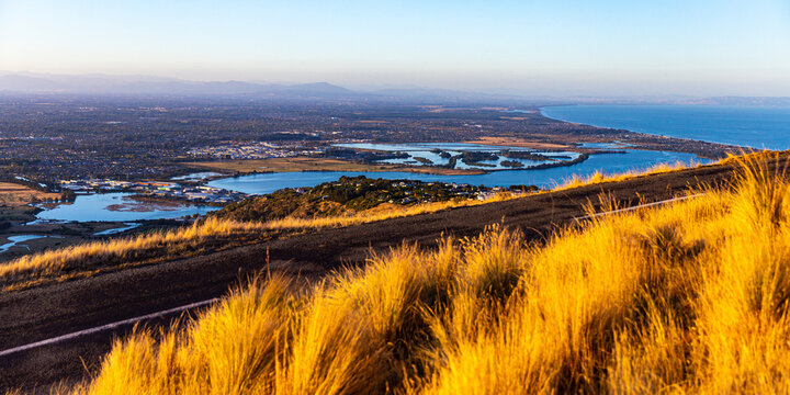 sunset over christchurch city and avon heathcote estuary seen from the summit road near john britten reserve; 