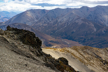 Rugged, rocky landscape of mountain ranges in Torlesse Tussocklands Park. Track to Castle Hill Peak, near Sheffield, Canterbury, new zealand south island. Mountains close to Christchurch. Mordor scene