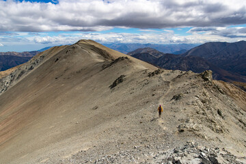 brave hiker climbing a steep, highly challenging track to Castle Hilll Peak in Korowai/Torlesse...