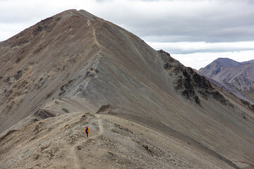 hiker girl walking alongside the ridge between castle hill peak and foggy peak near porters pass in...