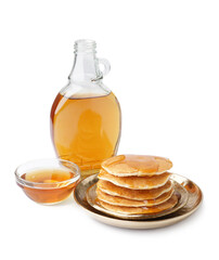 Plates of tasty pancakes with maple syrup on white background