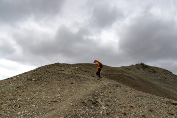 hiker girl walking alongside the ridge between castle hill peak and foggy peak near porters pass in...