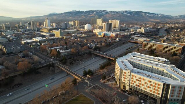 RENO - 2.22.2024 - Excellent aerial footage of highway traffic outside Reno Nevada, with a glimpse of the Silver Legacy Casino in the distance.
