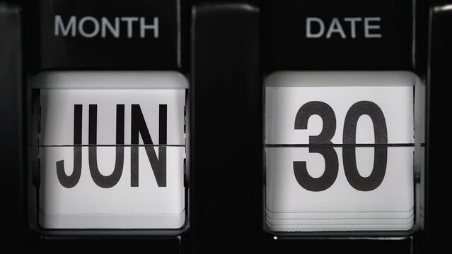 retro flip calendar with a date change from the twenty-ninth of June to the thirtieth of June. daily calendar with a change of days of the month. close up.