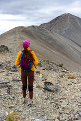 hiker girl admires the summit of castle peak hill, southern alps, canterbury, new zealand south...