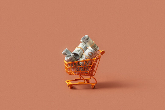 Small shopping trolley filled with bundles dollar banknotes