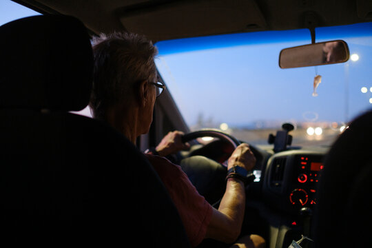 Senior Man Driving A Car At Night