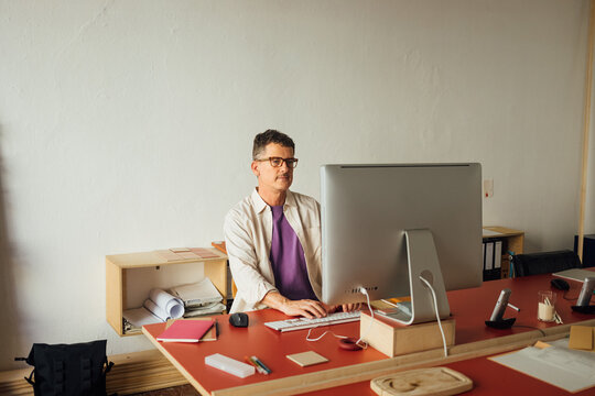 Man typing on keyboard in office
