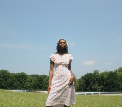 Girl in Gingham Dress in Field