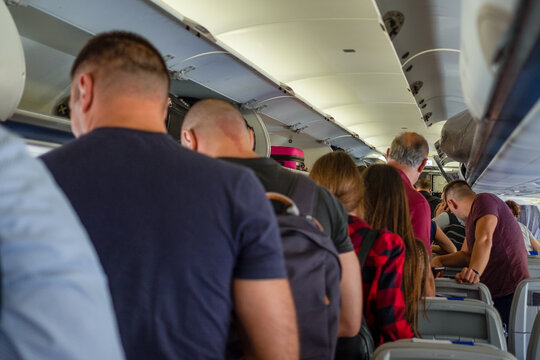 Passengers standing in an aeroplane during the flight