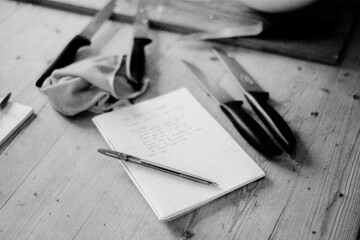 Recipe Notebook on a Wooden Table with Knives