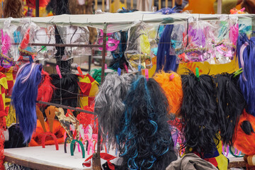 Street vendor selling carnival masks and hair accessories in Xanthi, Greece.