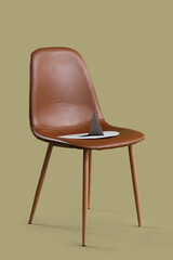 Chair with paper thumbtack on green background. Hemorrhoids concept