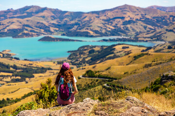 hiker girl admires the panorama of akaroa harbour and banks peninsula from the otepatotu scenic...