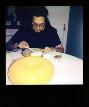 Polaroid Photo of Man Making Supper in the Kitchen