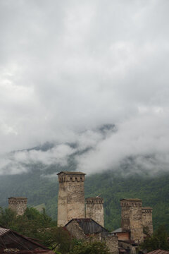 Misty Urban Architecture: Ancient Towers in Foggy Weather