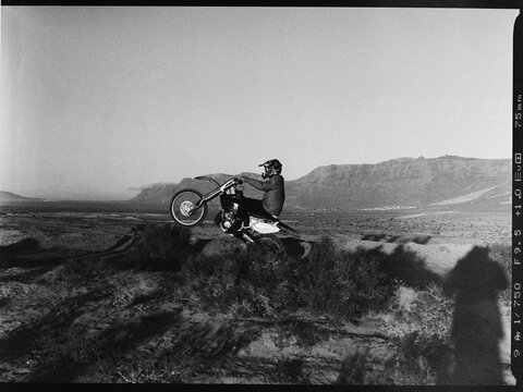 Motocross Rider Popping a Wheelie in Monochrome 