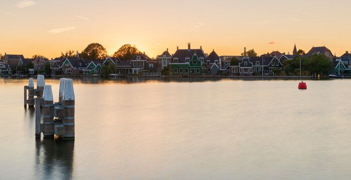 Traditional Houses Next To A Dutch Canal At Sunset  