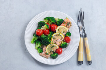 Salmon steak with vegetables, baked salmon fillet with broccoli and tomato, horizontal, top view
