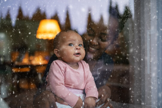 Mother and daughter watching snow