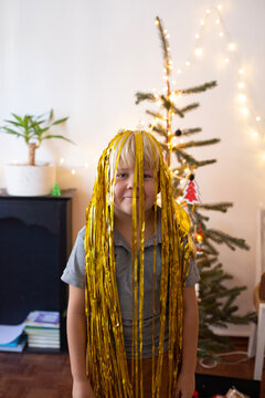 Smiling boy portrait with golden tinsel
