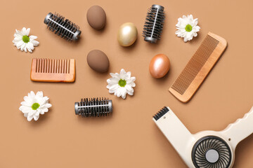 Fototapeta premium Hairdressing accessories with daisies and Easter eggs on light brown background