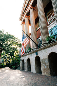 American flag proudly being displayed on a college campus. 