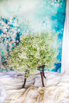 Huge Bouquet of Baby's Breath Sitting on Metal Chair in Front of Floral Backdrop, Colorful Floral Photograph for Spring, Wedding Aesthetic