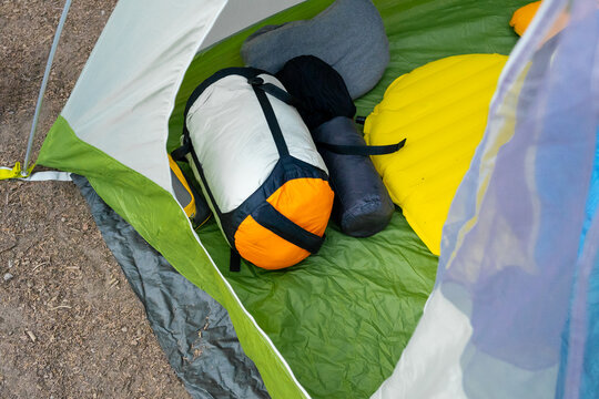 Camping gear in a tent outside.