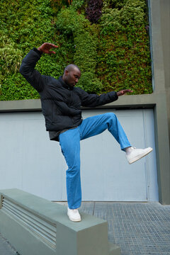 A portrait of an AfricanAmerican man playfully contorting.