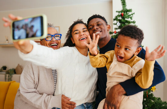 Happy family taking selfie on Christmas at home
