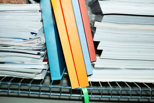 Colourful books a bookshelf with hard direct flashlight