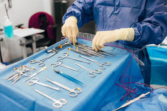 Cropped surgeon arranging medical instruments before surgery
