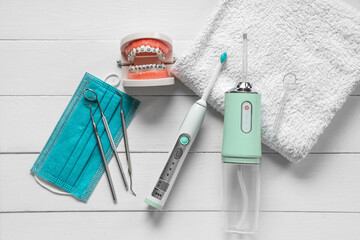 Set for oral hygiene with oral irrigator on white wooden  background