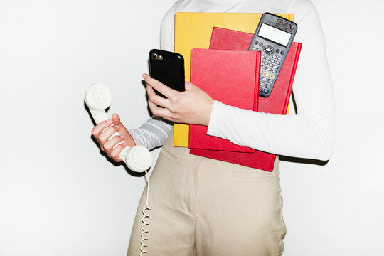 Bosslady holding landline, smartphone, calculator &  phone with flash