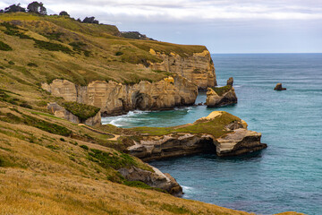 panorama of famous tunnel beach near dunedin and otago peninsula, new zealand south island; hidden...
