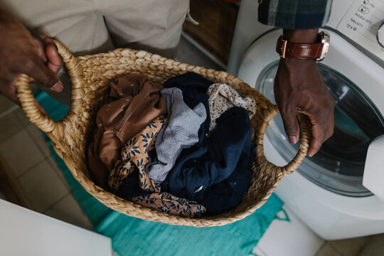 Man holding a basket with laundry