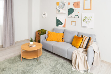 Fototapeta na wymiar Interior of modern living room with cozy sofa and coffee table