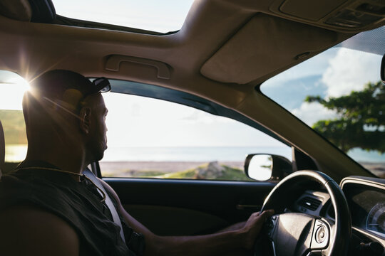 Man driving a rental car on the beach