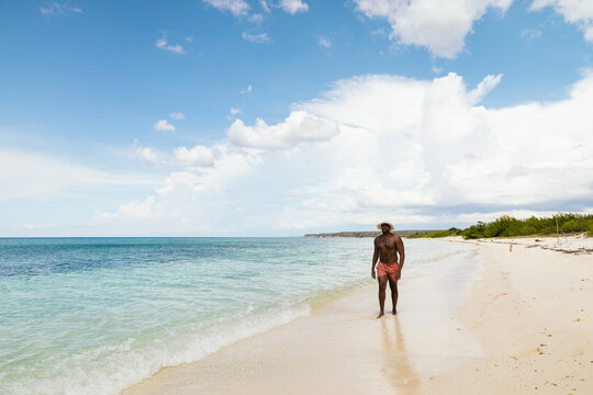man Walking On the beach On A Summer Day