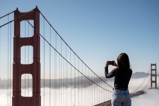 Tourist woman Taking A photo of Golden Gate Bridge